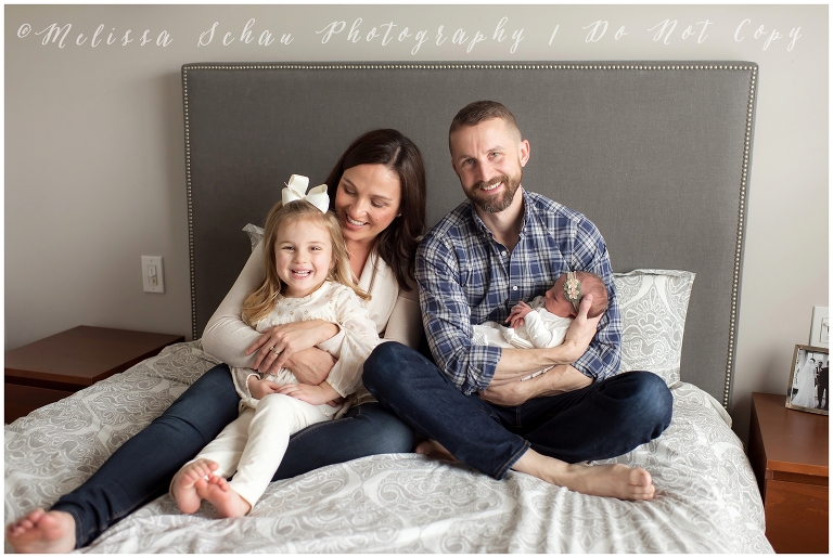 Newborn family photo on bed