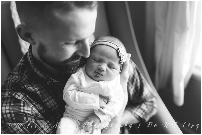 Dad holding newborn daughter