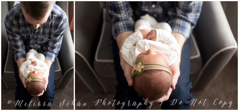 Dad holding newborn daughter