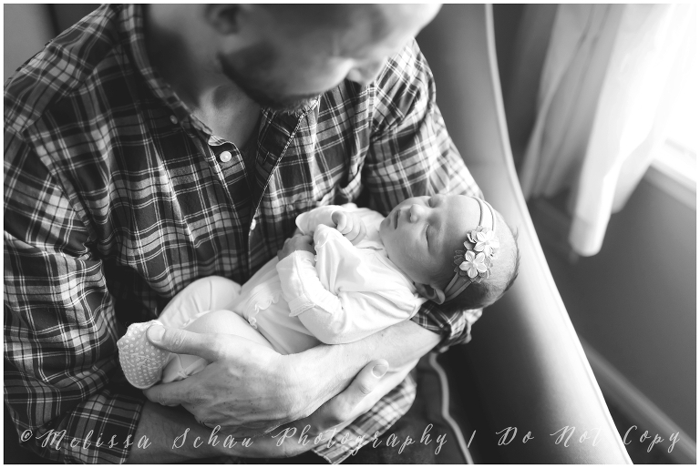 Dad holding newborn daughter