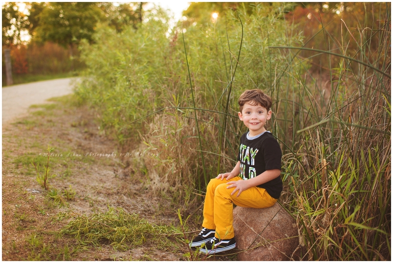 Child sitting on rock outdoor photography session