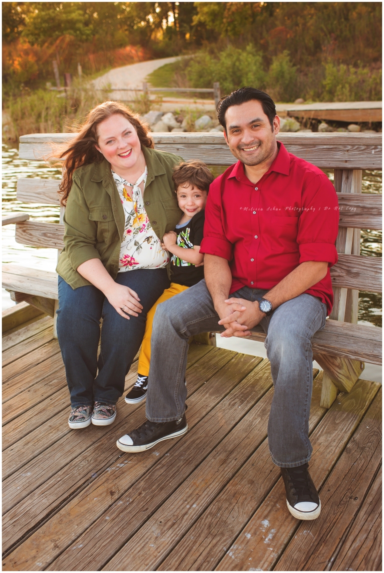 Family Outdoor Photography Session Sitting On Bench at Lake