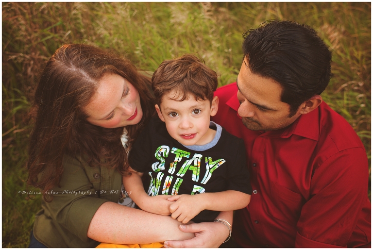 Family snuggling in grass outdoor photography session