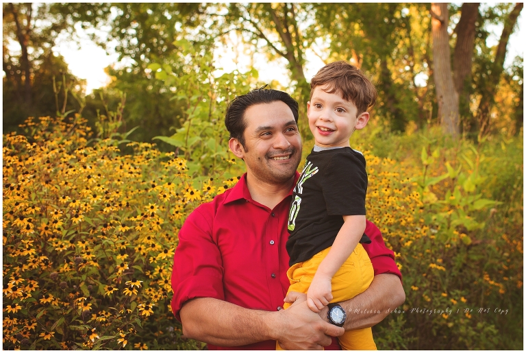 Dad and son outdoor golden hour photography session with flowers