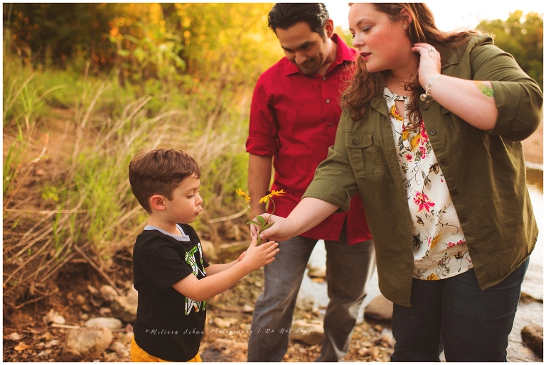 boy giving mom flower creek family photography session