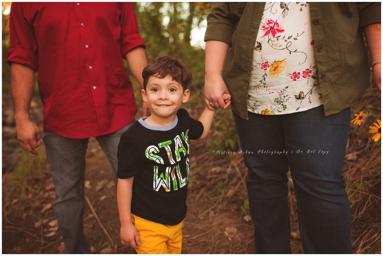 boy holding moms hand outdoor photography session