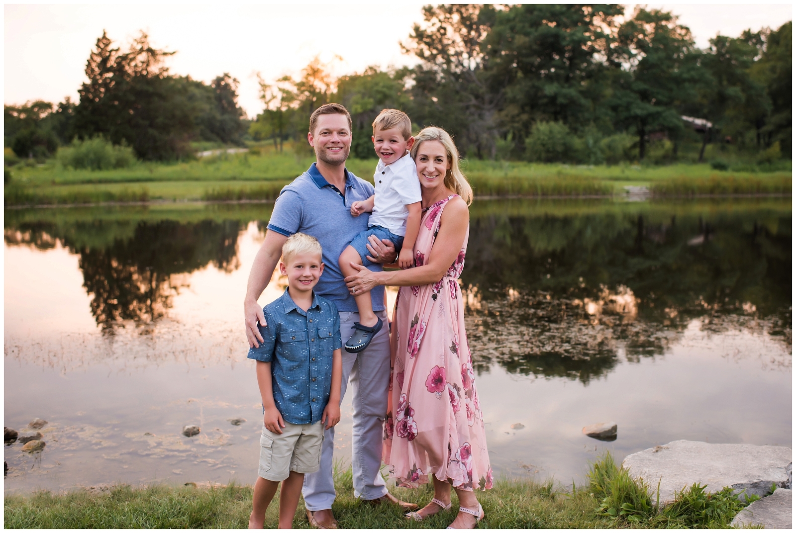 Family standing by lake