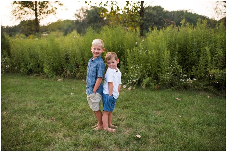 Two brothers standing back to back
